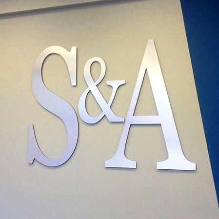 White dimensional letters S&A mounted on a wall