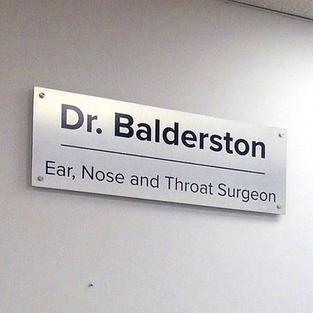 Brushed aluminum door sign for Dr. Balderston, Ear, Nose and Throat Surgeon